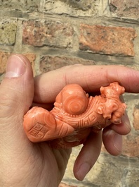 A set of seven Chinese red coral figures on wooden stand, 19/20th C.