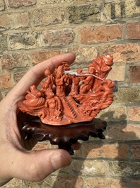 A Chinese red coral 'Eight Immortals' group on wooden stand, 19/20th C.