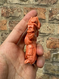 A set of seven Chinese red coral figures on wooden stand, 19/20th C.