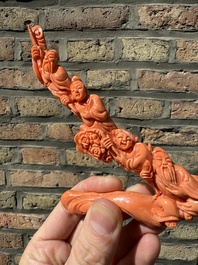 A Chinese red coral 'Eight Immortals' group on wooden stand, 19/20th C.