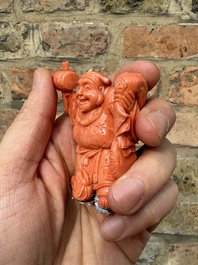 A set of seven Chinese red coral figures on wooden stand, 19/20th C.