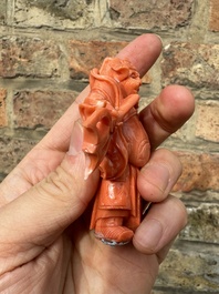 A set of seven Chinese red coral figures on wooden stand, 19/20th C.