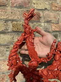 A large Chinese red coral group of female deities among clouds on wooden stand, 19/20th C.
