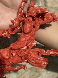 A large Chinese red coral group of female deities among clouds on wooden stand, 19/20th C.