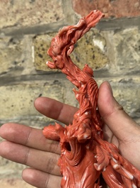 A large Chinese red coral group of female deities among clouds on wooden stand, 19/20th C.