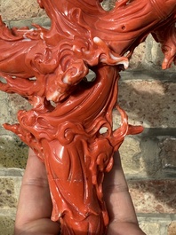A large Chinese red coral group of female deities among clouds on wooden stand, 19/20th C.