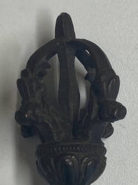 Four Tibetan bronze and wooden phurbas, a 'kapala' or skull-bowl, a pair of brass tingsha and two silver ornaments,  19th C.