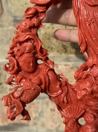 A large Chinese red coral group of female deities among clouds on wooden stand, 19/20th C.