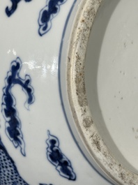 A Chinese blue and white bottle vase with dragons among flames and clouds, 19th C.
