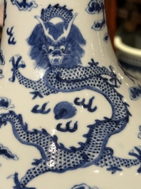 A Chinese blue and white bottle vase with dragons among flames and clouds, 19th C.