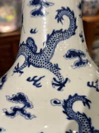 A Chinese blue and white bottle vase with dragons among flames and clouds, 19th C.