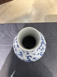 A Chinese blue and white bottle vase with dragons among flames and clouds, 19th C.