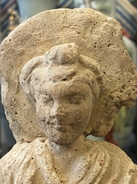 Two small Gandhara grey schist Bodhisattva heads, a stucco sculpture of Bodhisattva and a stucco female head, 1/4th C.