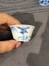 Thirteen Chinese blue and white saucers and twelve cups with figural design, Kangxi/Yongzheng