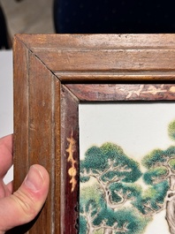 A Chinese famille rose 'two sages in the mountain' plaque in a wooden frame, 18/19th C.