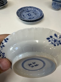 Eleven Chinese blue and white 'crab and fish' cups and saucers, Kangxi mark, Guangxu