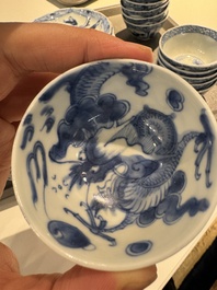 13 Chinese blue and white cups and 14 saucers with figural and dragon design, Kangxi/Yongzheng
