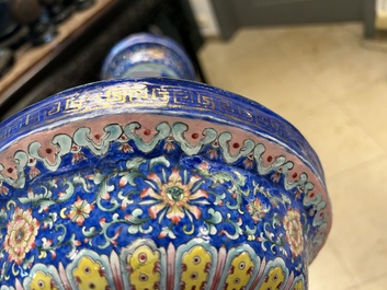 A large Chinese Canton enamel blue-ground 'shou' candlestick, Qianlong/Jiaqing