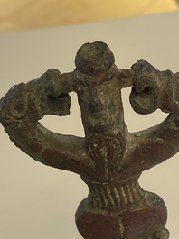 A collection of three bronze axes, a mirror and an anthropomorphic idol with two dragon heads, Luristan, 2000 B.C and earlier