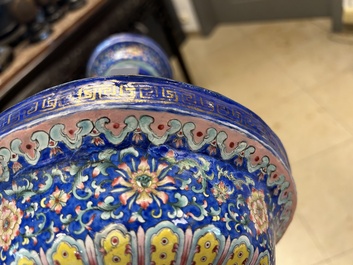 A large Chinese Canton enamel blue-ground 'shou' candlestick, Qianlong/Jiaqing