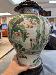 Two Chinese famille verte covered vases on wooden stands, 19th C.