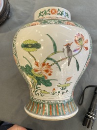 Two Chinese famille verte covered vases on wooden stands, 19th C.