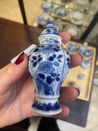 Fourteen Chinese blue and white miniature vases with floral design, Kangxi