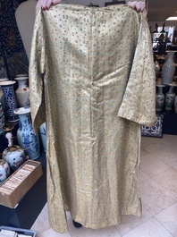 An Iranian gold-thread-embroidered silk caftan, a hat, a coin bracelet and a Koran holder, 19th C.