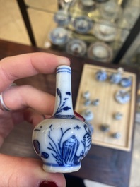 Fourteen Chinese blue and white miniature vases with floral design, Kangxi