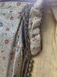 An Iranian gold-thread-embroidered silk caftan, a hat, a coin bracelet and a Koran holder, 19th C.