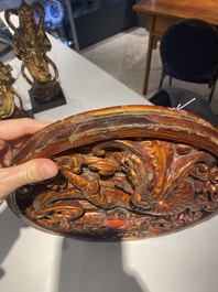 A pair of Chinese gilt-lacquered wooden guardians and a round 'dragon' plaque, 19th C.
