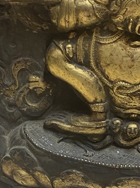 A Tibetan gilt copper 'Mahakala' plaque, 19th C.