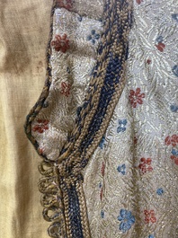 An Iranian gold-thread-embroidered silk caftan, a hat, a coin bracelet and a Koran holder, 19th C.