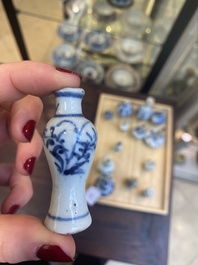 Fourteen Chinese blue and white miniature vases with floral design, Kangxi