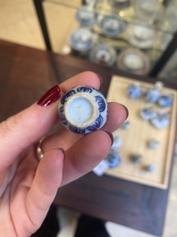 Fourteen Chinese blue and white miniature vases with floral design, Kangxi