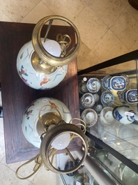 A pair of Chinese famille rose 'Eight Immortals' jars mounted as lamps, 19th C.