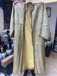 An Iranian gold-thread-embroidered silk caftan, a hat, a coin bracelet and a Koran holder, 19th C.