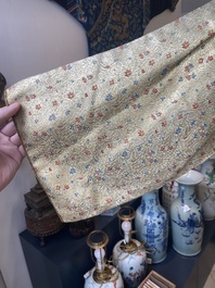 An Iranian gold-thread-embroidered silk caftan, a hat, a coin bracelet and a Koran holder, 19th C.