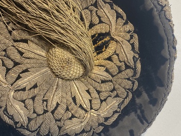 An Iranian gold-thread-embroidered silk caftan, a hat, a coin bracelet and a Koran holder, 19th C.