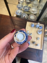 Fourteen Chinese blue and white miniature vases with floral design, Kangxi