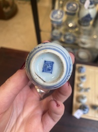 Fourteen Chinese blue and white miniature vases with floral design, Kangxi
