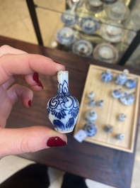 Fourteen Chinese blue and white miniature vases with floral design, Kangxi