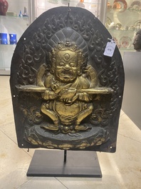 A Tibetan gilt copper 'Mahakala' plaque, 19th C.