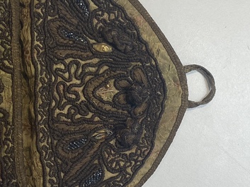 An Iranian gold-thread-embroidered silk caftan, a hat, a coin bracelet and a Koran holder, 19th C.