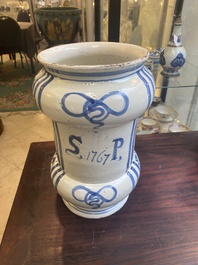 A large Italian blue, white and manganese albarello drug jar inscribed Charitas, probably Savona, dated 1767