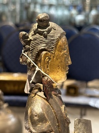 A pair of Chinese partly lacquered and gilt bronze figures of female attendants, Ming