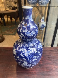 A Chinese blue and white double gourd 'prunus on cracked ice' vase, 18th C.