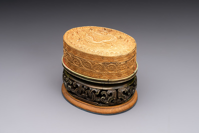 An oval Chinese imperial gold and silver filigree lidded 'dragon' box on reticulated stand and with presentation box, Qianlong mark and of the period