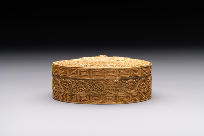 An oval Chinese imperial gold and silver filigree lidded 'dragon' box on reticulated stand and with presentation box, Qianlong mark and of the period