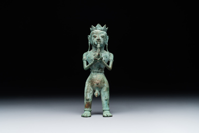 An fine Indonesian bronze sculpture of a naked man offering a sacrificial vase, Majapahit, East Java, 13/14th C.